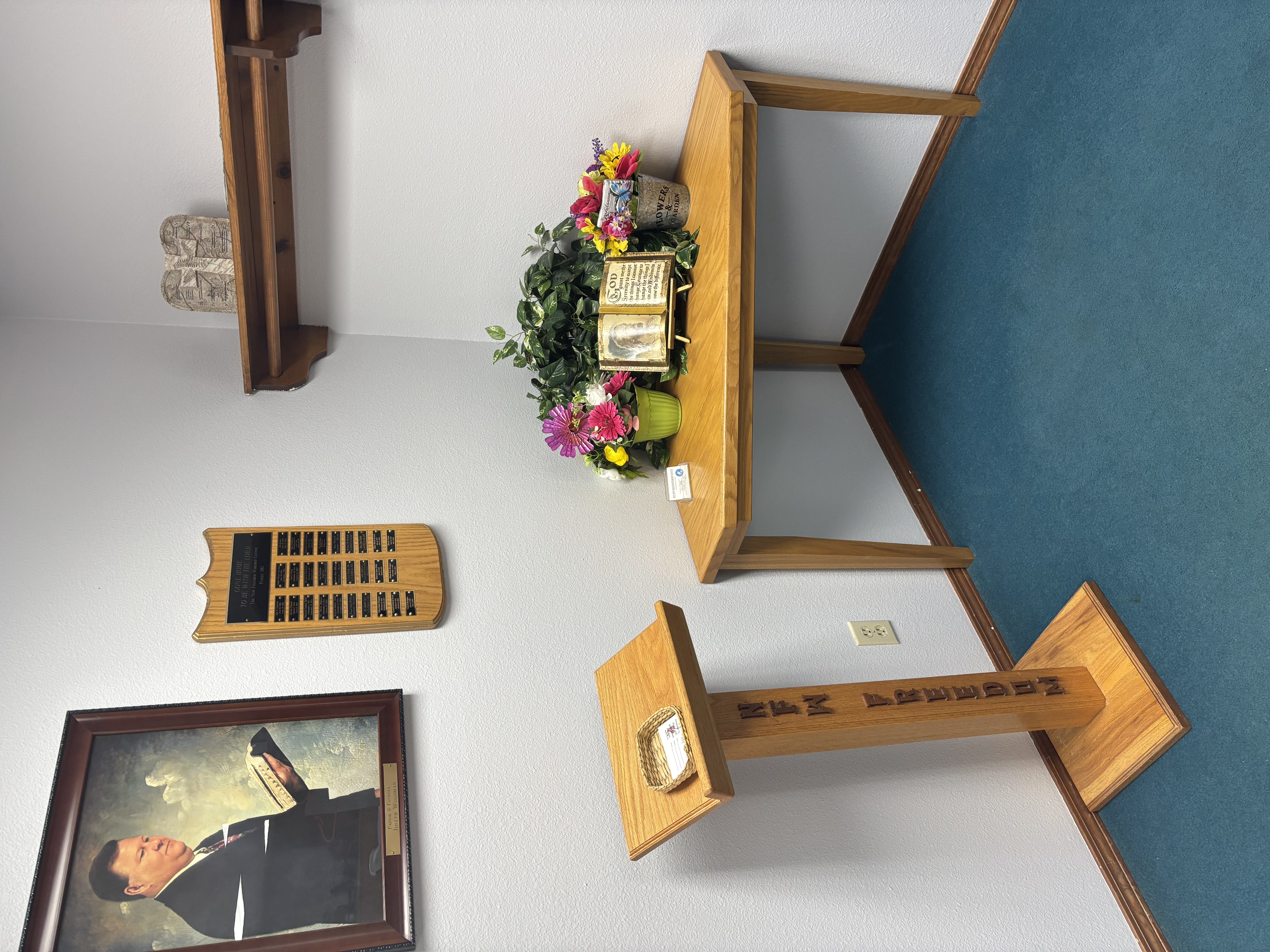 Image of the lobby of the church, along with painting of Pastor Joe Wogoman